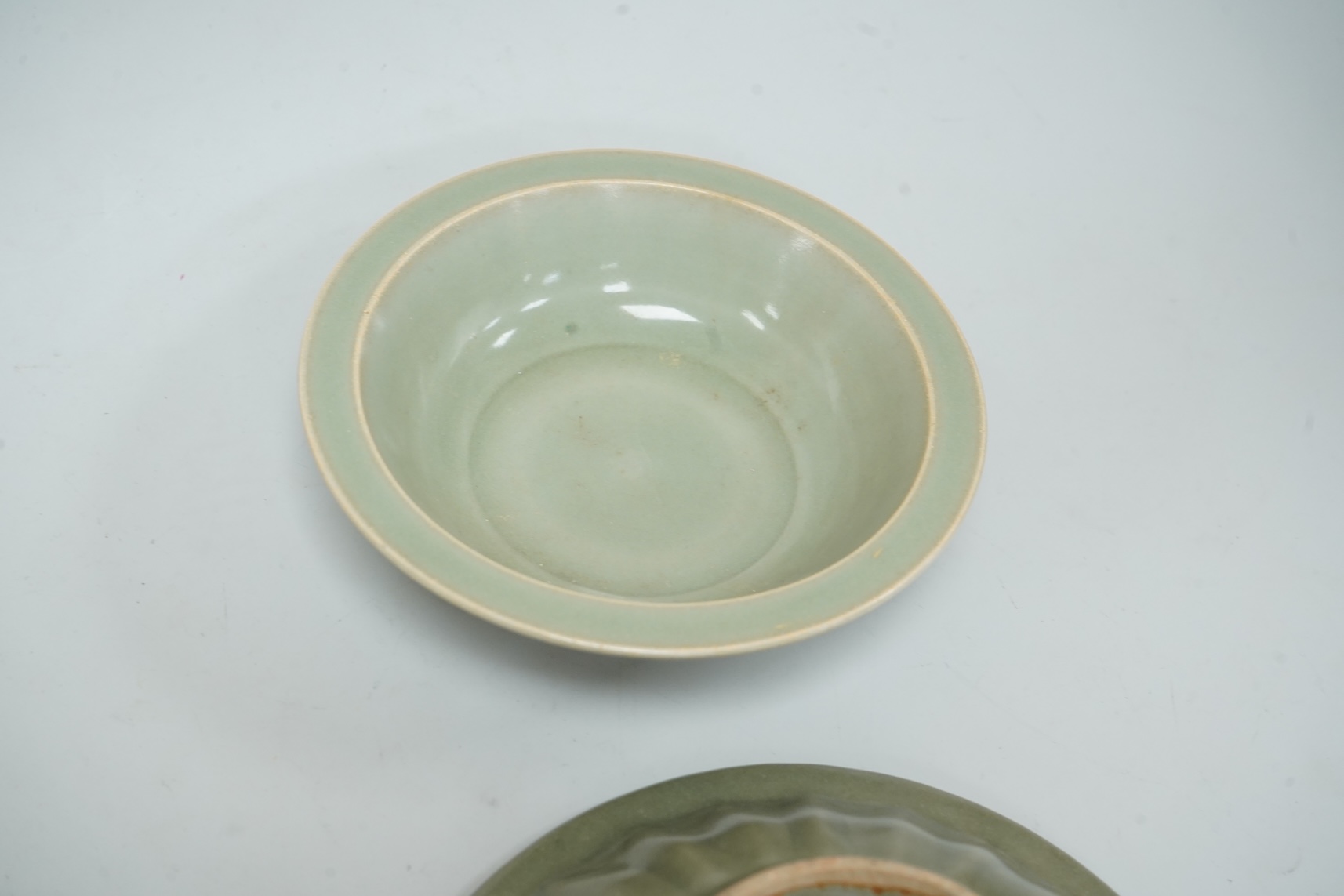 A Chinese celadon glazed twin fish dish, another similar and a white glazed bowl, largest 13.5cm